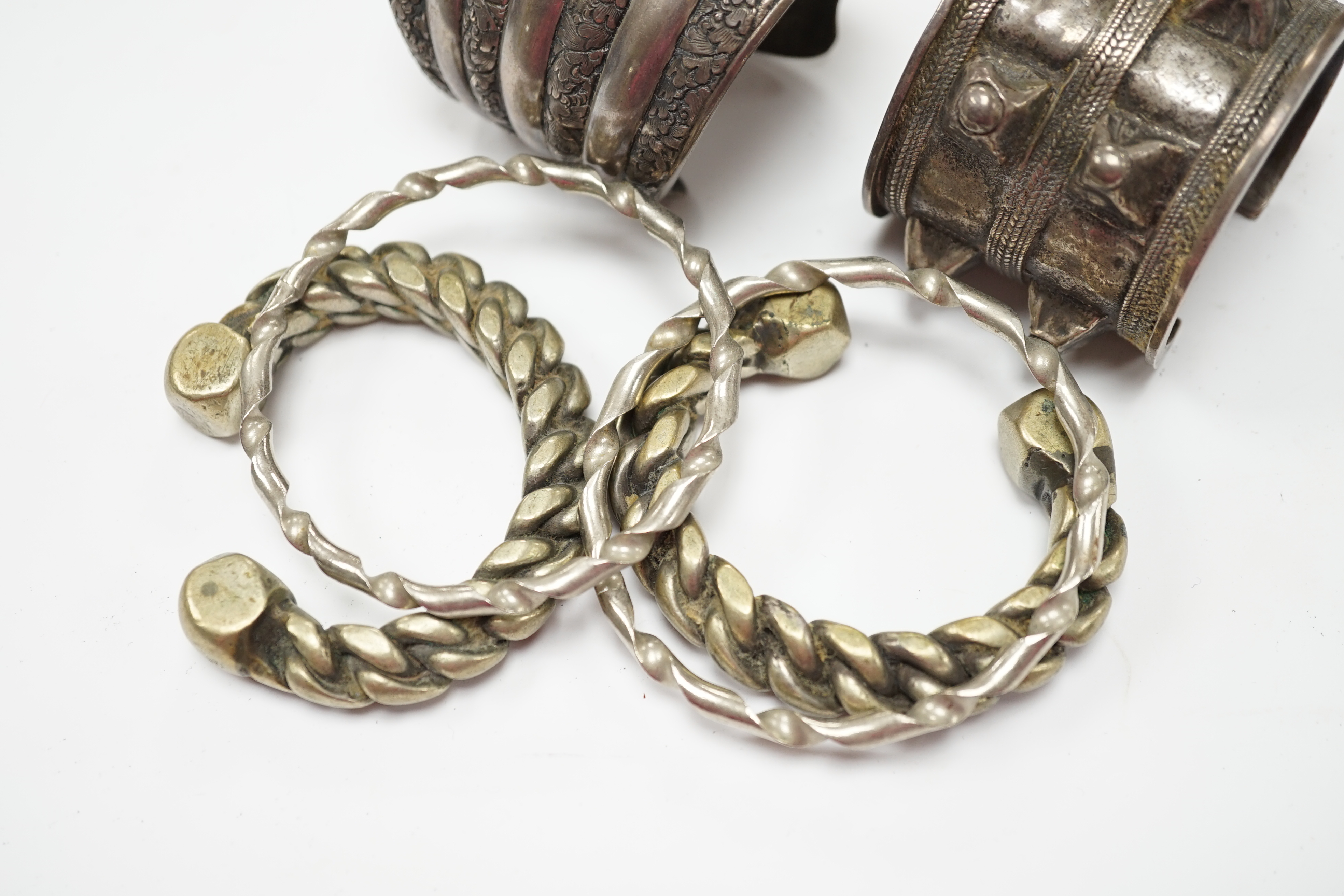 Six assorted Egyptian bracelets, including white metal bangles and two white metal cuff bracelets. Fair condition.